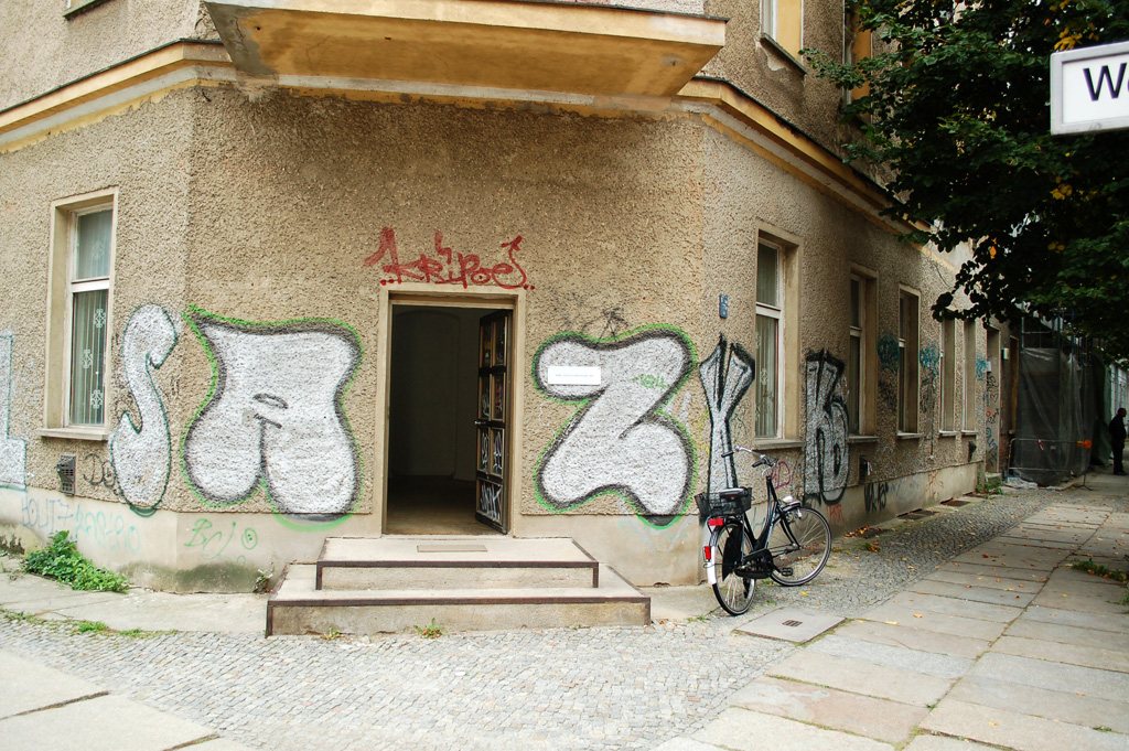 local.#non.access — the km temporaer doorway with tag-covered walls