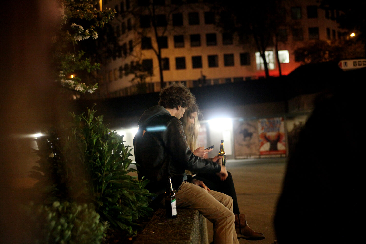 LocalNonOffline — two visitors on the planter wall at night, phone and beer bottles